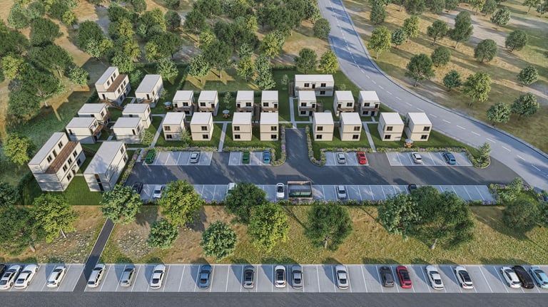 Aerial view of a modern residential development with white townhouses arranged in rows, surrounding parking areas, and green landscaping